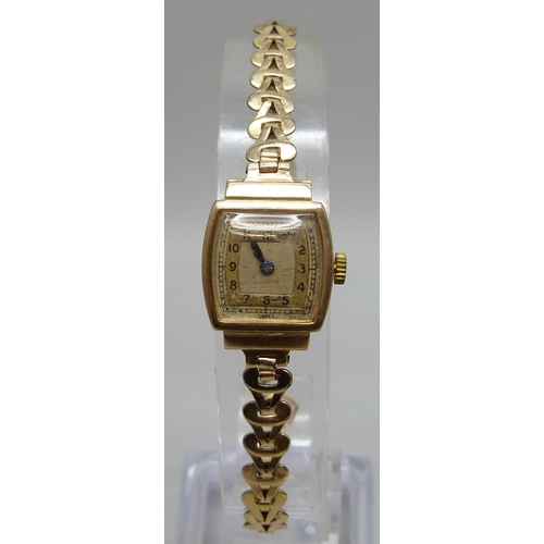 7294 - A lady's 9ct gold wristwatch on a rolled gold bracelet, together with a pair of Art Deco silver cuff... 