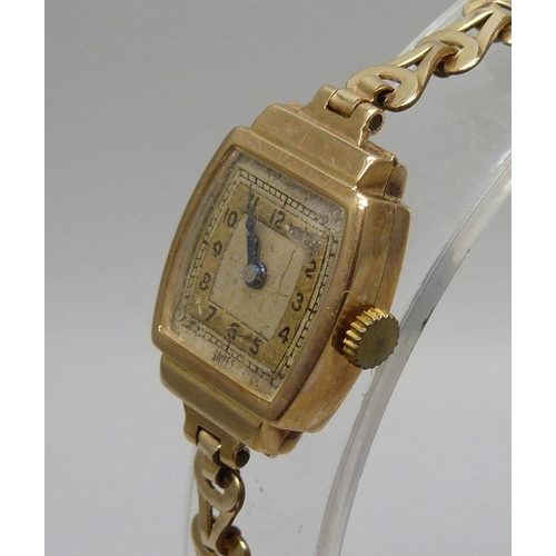 7294 - A lady's 9ct gold wristwatch on a rolled gold bracelet, together with a pair of Art Deco silver cuff... 