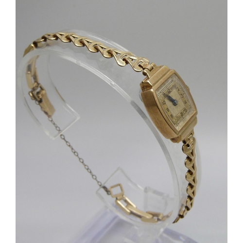 7294 - A lady's 9ct gold wristwatch on a rolled gold bracelet, together with a pair of Art Deco silver cuff... 