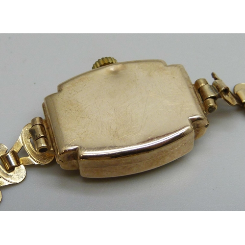 7294 - A lady's 9ct gold wristwatch on a rolled gold bracelet, together with a pair of Art Deco silver cuff... 