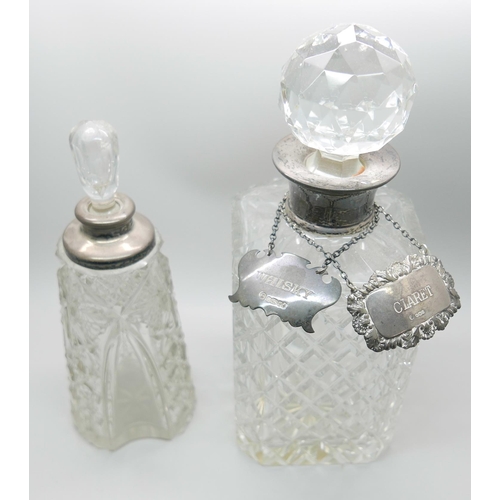 7321 - A silver mounted glass scent bottle, a silver mounted glass decanter and two silver labels, whisky a... 