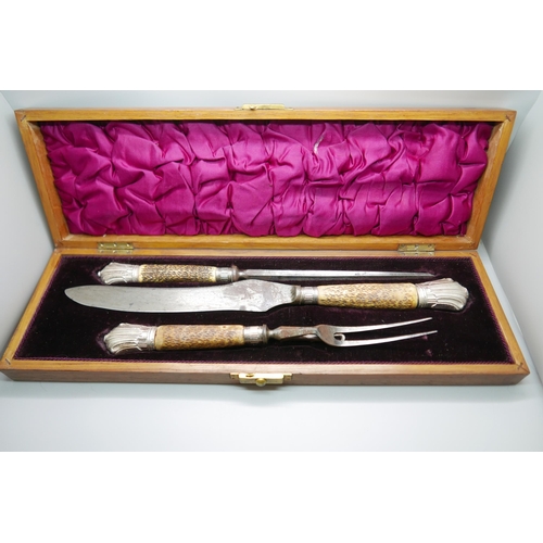 7335 - A Victorian antler handled three piece carving set with silver mounts, Sheffield 1883, cased