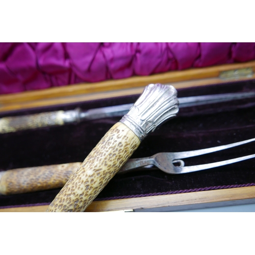 7335 - A Victorian antler handled three piece carving set with silver mounts, Sheffield 1883, cased