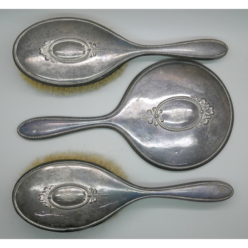 7336 - Two silver back brushes and a hand mirror by Walker & Hall