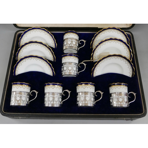 7338 - A cased set of six Aynsley coffee cans and saucers with silver holders, 108g of silver, (two cans an... 