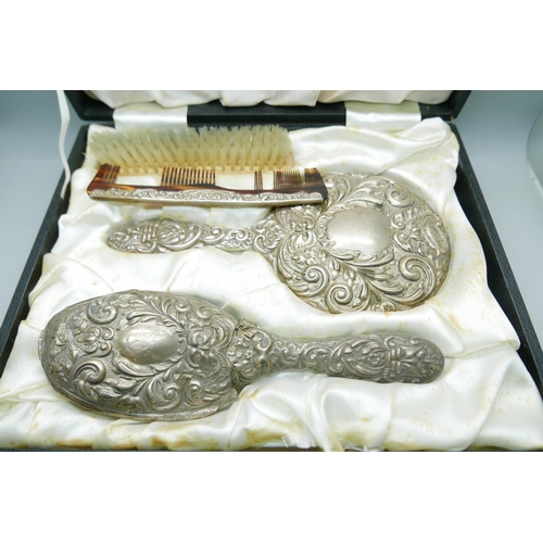 7341 - A silver backed vanity set including hand mirror, a/f