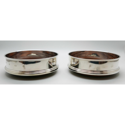 7342 - A pair of silver wine coasters