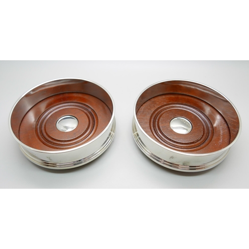 7342 - A pair of silver wine coasters