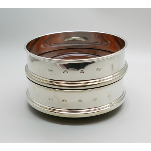 7342 - A pair of silver wine coasters