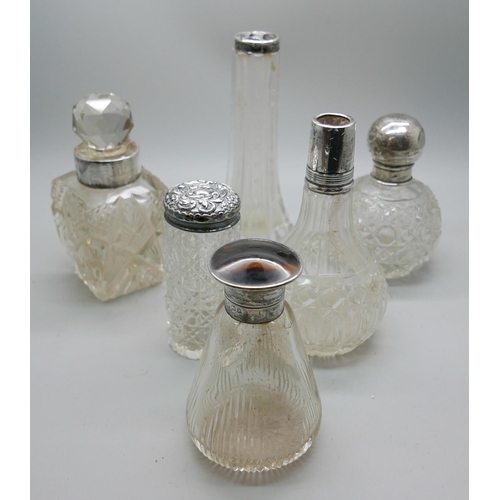 7352 - A box of silver topped cut glass jars and scents, including one Birmingham 1923, one lacking stopper