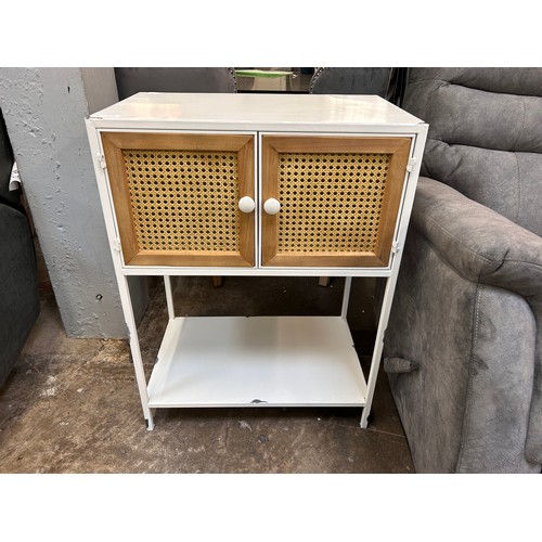 3143 - A white painted metal industrial style cupboard with rattan detail