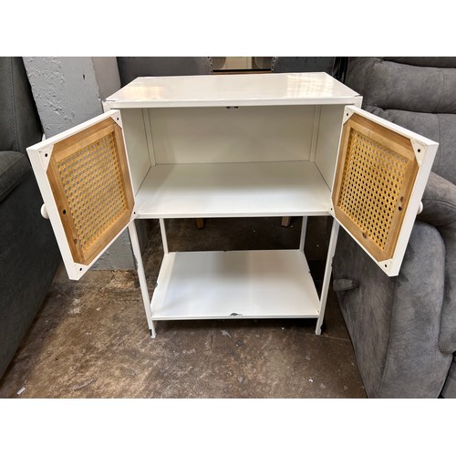 3143 - A white painted metal industrial style cupboard with rattan detail