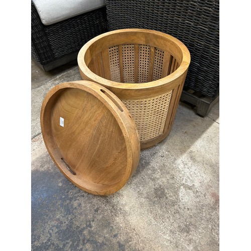 3097 - A round rattan and mango wood side table with storage *This lot is subject to VAT