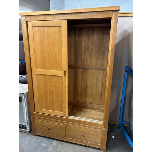 3125 - An oak Sliding two door, two drawer wardrobe