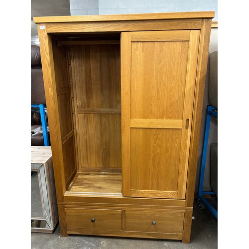 3125 - An oak Sliding two door, two drawer wardrobe