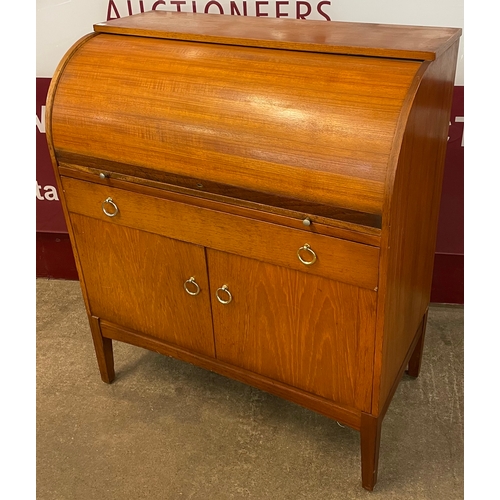 19 - A teak cylinder top desk