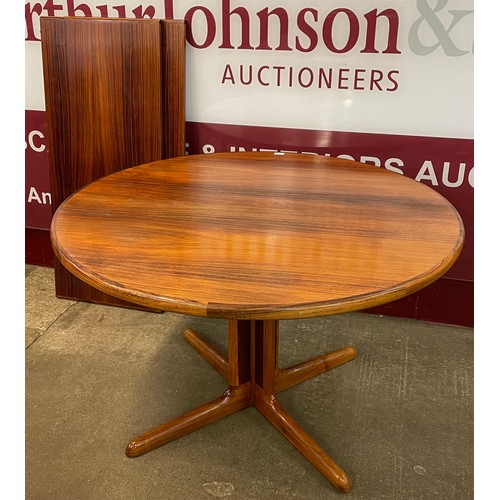 60 - A Danish simulated rosewood circular extending dining table