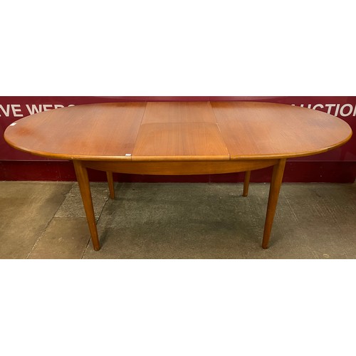 65 - A Jentique teak oval extending dining table and four chairs