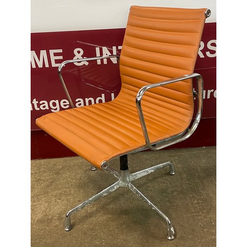 83 - An Eames style chrome and tan leather revolving desk chair