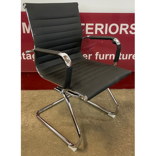 84 - An Eames style chrome and black vinyl cantilever armchair