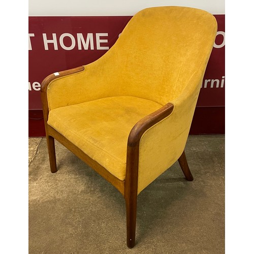 86 - A teak and mustard yellow fabric upholstered armchair