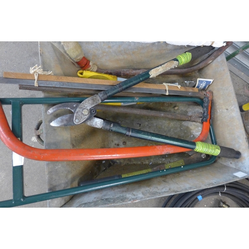 5174 - A wheelbarrow and a large quantity of garden tools including a garden hose, a Premier 5L Hozelock ha... 