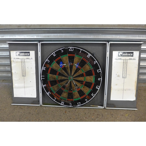 5234 - A dartboard with darts and a collection of various snooker cues including Rileys Eclipse in hard cas... 