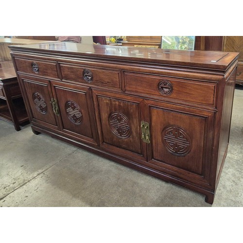 204 - A Chinese hardwood four door sideboard