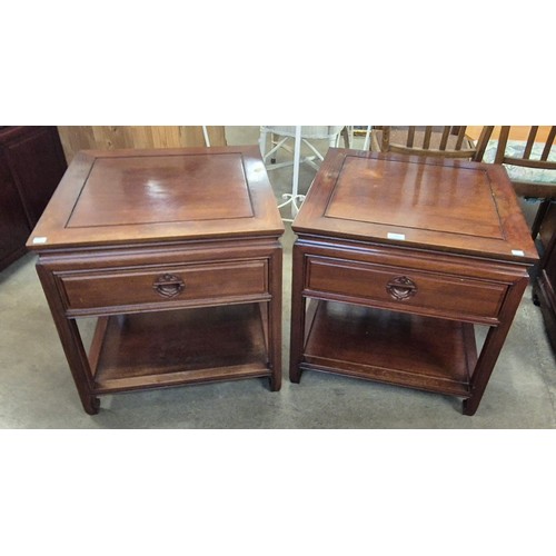 206 - A pair of Chinese hardwood single drawer lamp tables