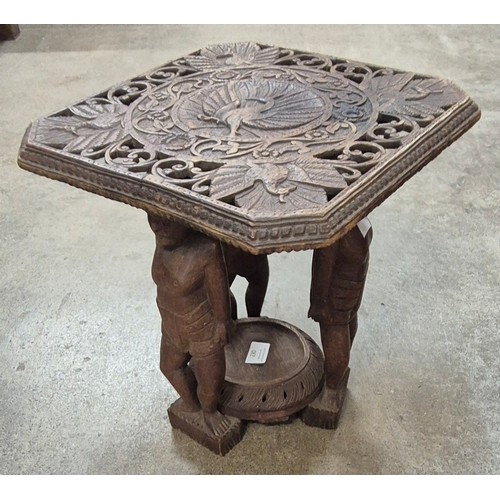 230 - A small Indonesian carved wood table