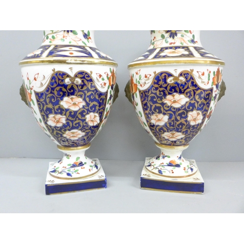 2008C - Two 19th Century Crown Derby Imari vases, one with restored rim, 23cm