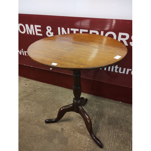 146 - A George III mahogany and oak circular tilt top tripod tea table