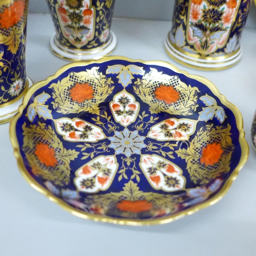 2062 - A collection of Hamilton Imari porcelain; two pin dishes, a saucer, four vases and a cup (one vase a... 