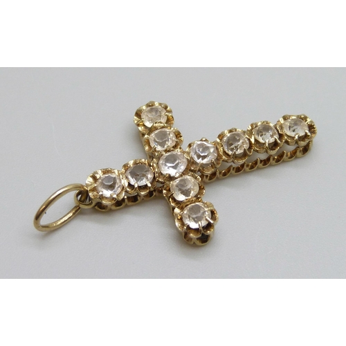 7001 - A yellow metal stone set cross pendant, tests as high carat gold, hanging loop marked 18ct, 3.8g