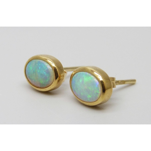 7015 - A pair of 18ct gold opal stud earrings, boxed, 2.4g