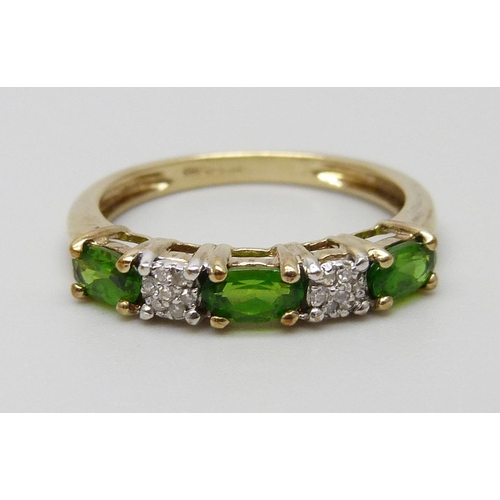 7019 - A 9ct gold, diamond and green stone ring, set with two clusters of seven diamonds, 1.8g, N