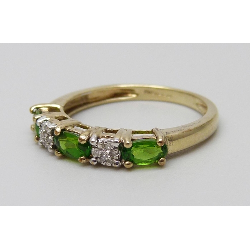 7019 - A 9ct gold, diamond and green stone ring, set with two clusters of seven diamonds, 1.8g, N