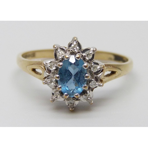 7022 - A 9ct gold, topaz and white stone cluster ring, 2.1g, P