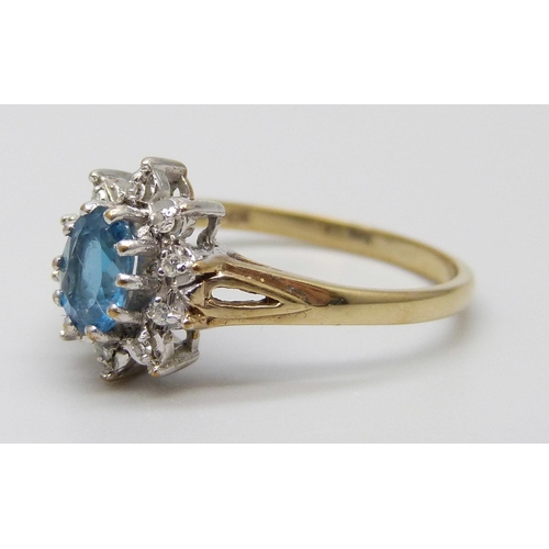 7022 - A 9ct gold, topaz and white stone cluster ring, 2.1g, P