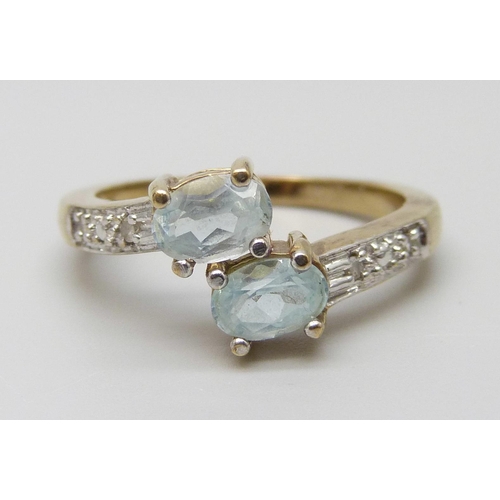 7036 - A 9ct gold, aquamarine and diamond crossover ring, 3.5g, P