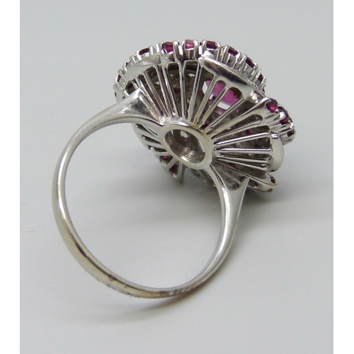 7047 - A large ruby and diamond cocktail cluster ring, white metal tests as 18ct gold, rubies 1.40 carat es... 