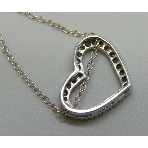 7051 - A 9ct white gold and diamond heart shaped pendant, 1.6g, (the fine silver chain requires a fastener)