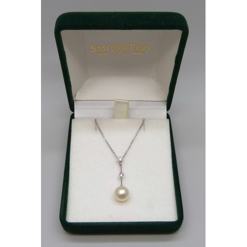 7060 - A 9ct white gold, diamond and pearl pendant on a fine 9ct white gold chain, 2.1g, chain 42cm