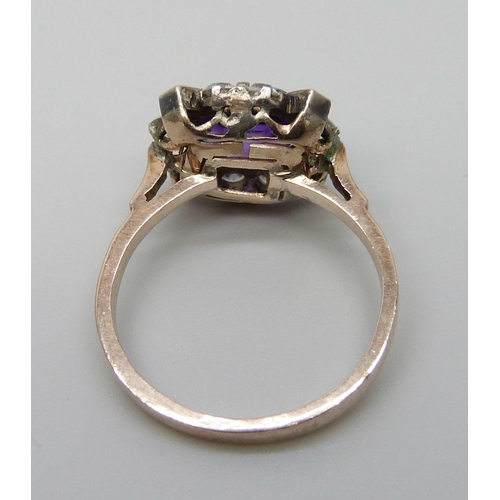 7064 - A yellow metal ring set with a central amethyst and white stones, 3g, M