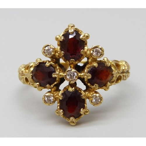 7091 - A 18ct gold, garnet and diamond ring, 5.9g, P