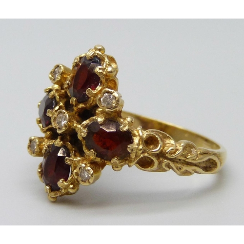 7091 - A 18ct gold, garnet and diamond ring, 5.9g, P