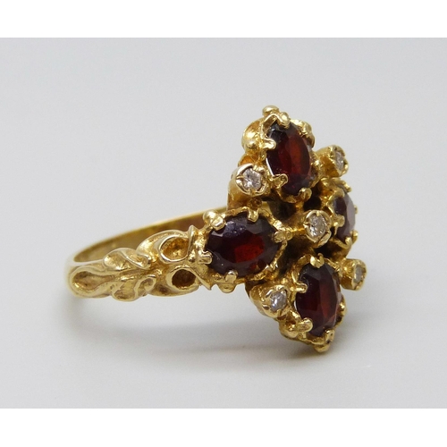 7091 - A 18ct gold, garnet and diamond ring, 5.9g, P