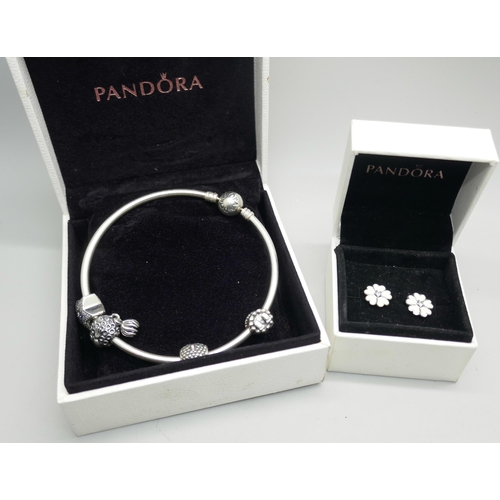 7109 - A silver Pandora bracelet with charms and a pair of silver Pandora earrings