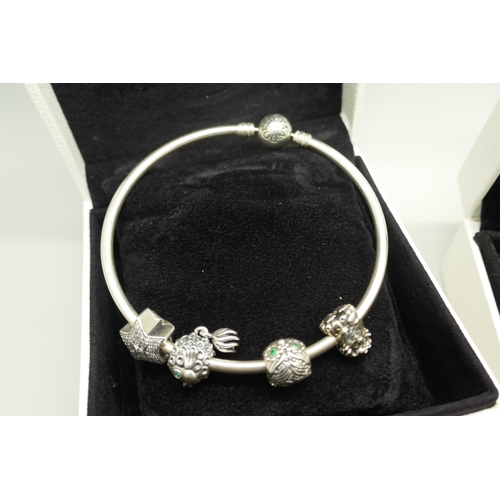 7109 - A silver Pandora bracelet with charms and a pair of silver Pandora earrings