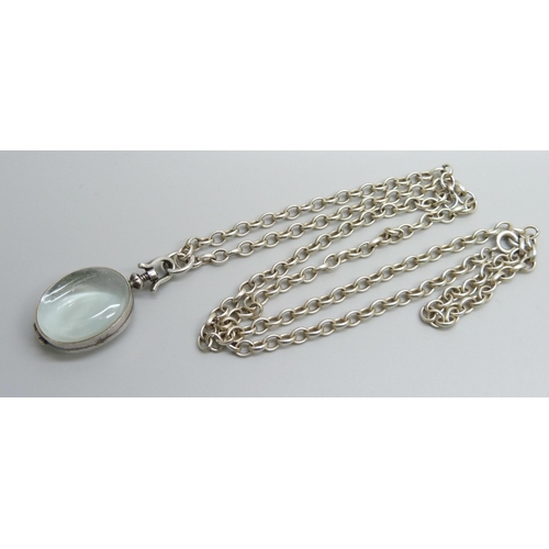 7174 - A rock crystal locket pendant on a long silver belcher chain, 45g, 4.5cm including bale, 75cm chain